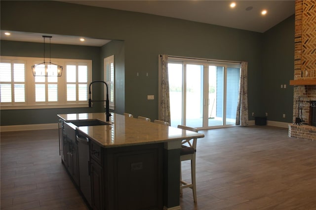 2437 Bay Lake Loop, Groveland, FL 34736 - kitchen featuring wood finished floors, open floor plan, recessed lighting, a sink, and dishwasher