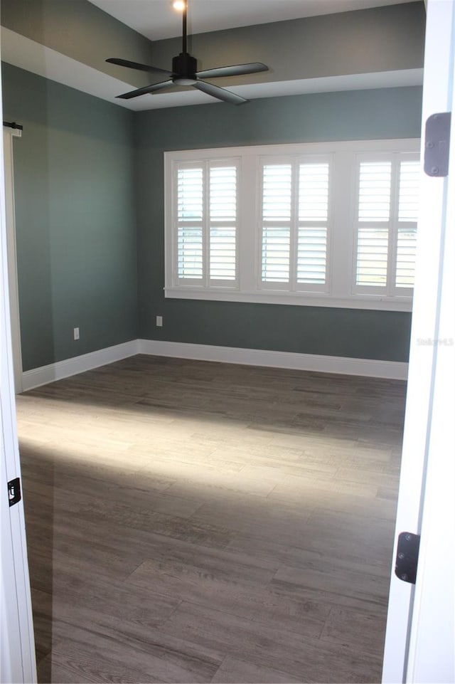 2437 Bay Lake Loop, Groveland, FL 34736 - empty room with ceiling fan, dark wood-style floors, and baseboards