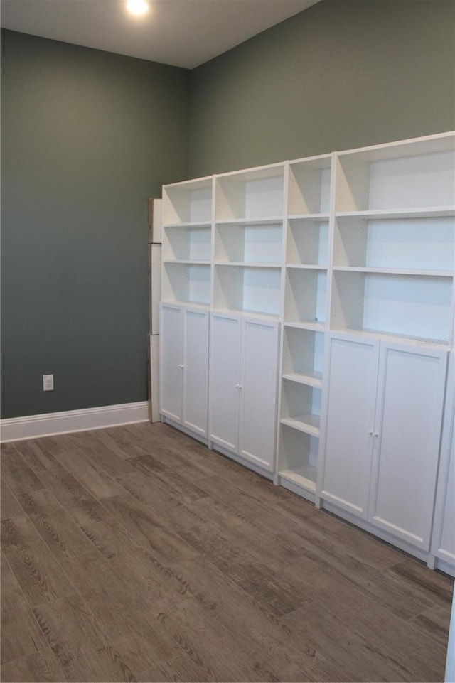 2437 Bay Lake Loop, Groveland, FL 34736 - unfurnished bedroom with dark wood-type flooring and baseboards
