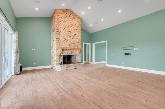 2437 Bay Lake Loop, Groveland, FL 34736 - unfurnished living room with high vaulted ceiling, light wood-style floors, and a fireplace