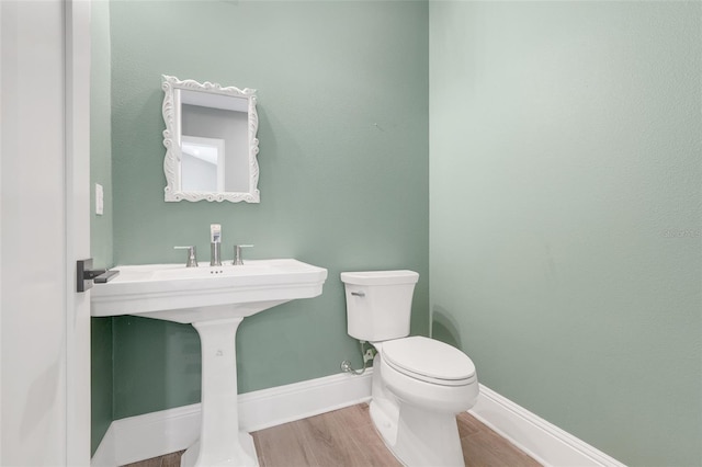 2437 Bay Lake Loop, Groveland, FL 34736 - half bath featuring toilet and wood finished floors