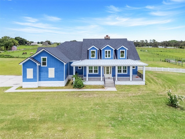 2437 Bay Lake Loop, Groveland, FL 34736 - view of front of property featuring a chimney, a porch, a metal roof, a standing seam roof, and a rural view