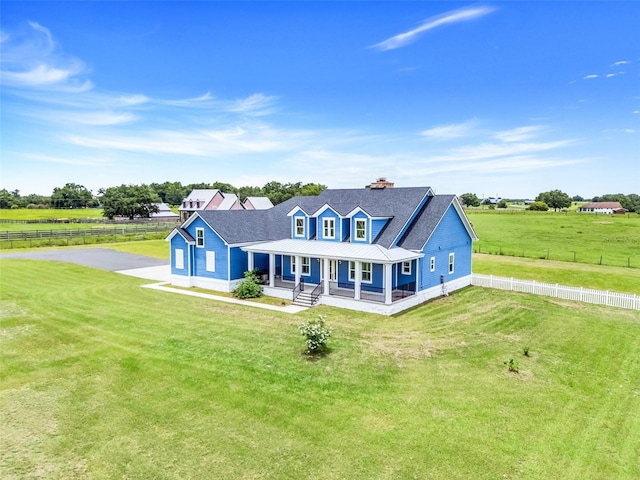 2437 Bay Lake Loop, Groveland, FL 34736 - farmhouse inspired home featuring a porch, driveway, a metal roof, a chimney, and a rural view