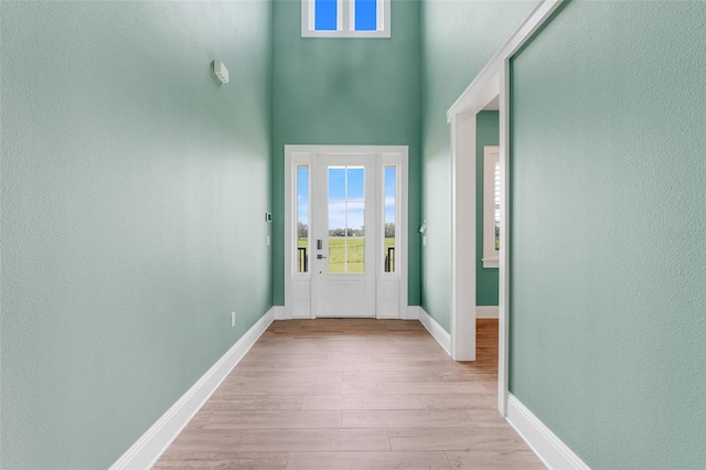 2437 Bay Lake Loop, Groveland, FL 34736 - foyer entrance featuring wood finished floors, a high ceiling, and a textured wall