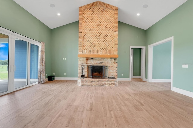 2437 Bay Lake Loop, Groveland, FL 34736 - unfurnished living room featuring high vaulted ceiling, light wood finished floors, and a fireplace
