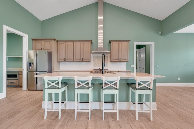 2437 Bay Lake Loop, Groveland, FL 34736 - kitchen with stainless steel refrigerator with ice dispenser, a large island with sink, high vaulted ceiling, decorative backsplash, and light countertops