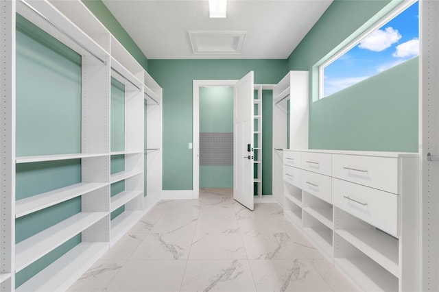 2437 Bay Lake Loop, Groveland, FL 34736 - walk in closet featuring light marble finish flooring and attic access