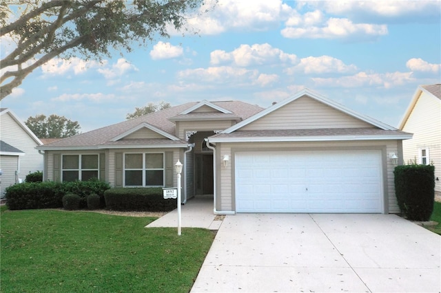 view of front facade featuring a garage and a front lawn