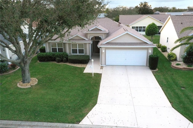 view of front facade with a garage and a front lawn