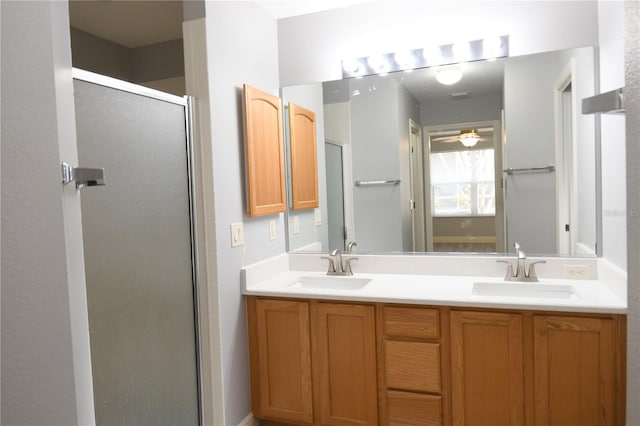 bathroom featuring vanity, a shower with door, and ceiling fan