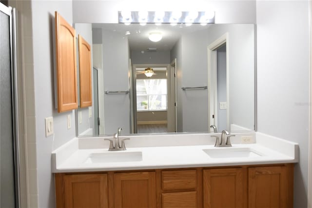 bathroom with vanity, a shower with door, and ceiling fan