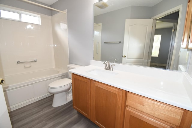 full bathroom with vanity, hardwood / wood-style floors, tub / shower combination, and toilet