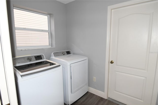 laundry area with washer and dryer and dark wood-type flooring