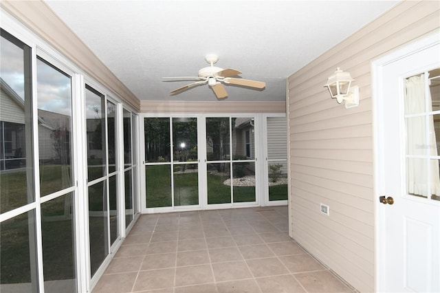 unfurnished sunroom with ceiling fan