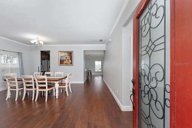 dining space featuring ornamental molding, dark hardwood / wood-style floors, and a notable chandelier