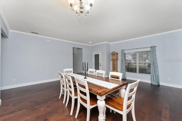 dining room featuring dark hardwood / wood-style flooring, crown molding, and a chandelier