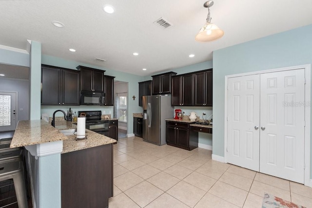 kitchen featuring black appliances, dark brown cabinets, light tile patterned floors, and sink