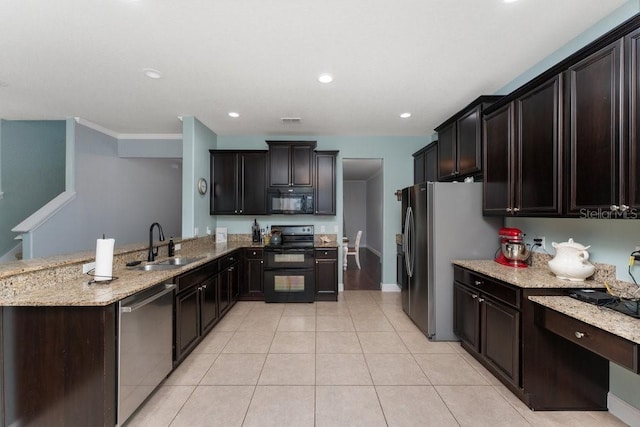 kitchen with black appliances, dark brown cabinets, light stone counters, and sink