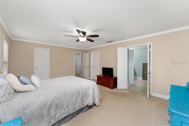 carpeted bedroom with ceiling fan and ornamental molding