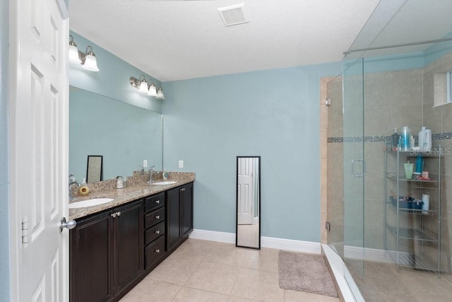 bathroom featuring tile patterned floors, vanity, and walk in shower