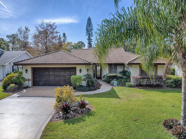 single story home featuring a front lawn and a garage