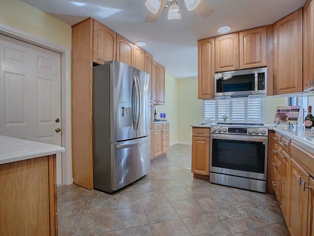 kitchen with ceiling fan and appliances with stainless steel finishes