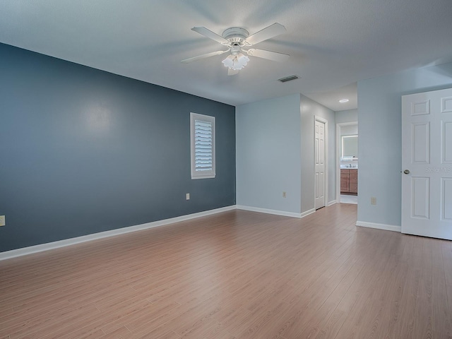 spare room featuring ceiling fan and light hardwood / wood-style floors