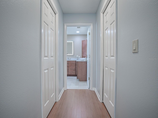 corridor featuring light hardwood / wood-style flooring