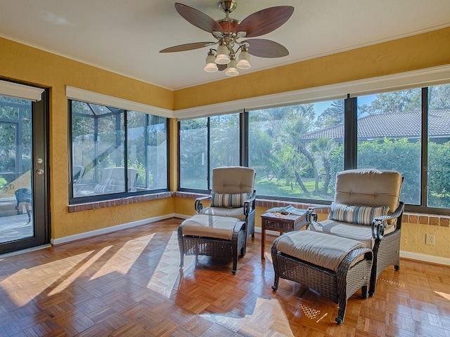 sunroom featuring ceiling fan and a healthy amount of sunlight