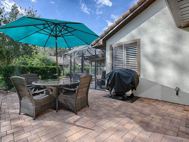 view of patio / terrace with area for grilling and glass enclosure