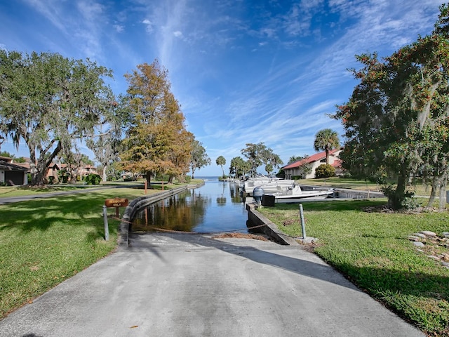 dock area featuring a yard and a water view