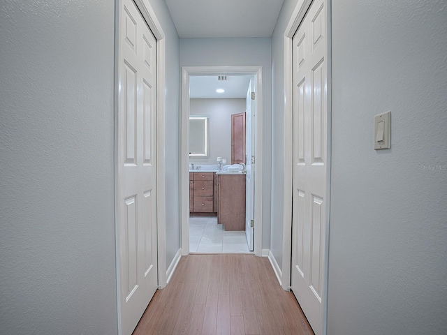 102 Cedar Way, Yalaha, FL 34797 - corridor featuring wood finished floors and baseboards