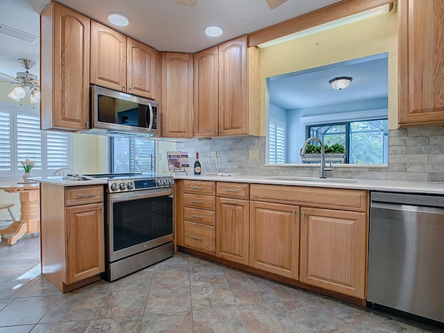 102 Cedar Way, Yalaha, FL 34797 - kitchen with stainless steel appliances, a ceiling fan, light countertops, and tasteful backsplash
