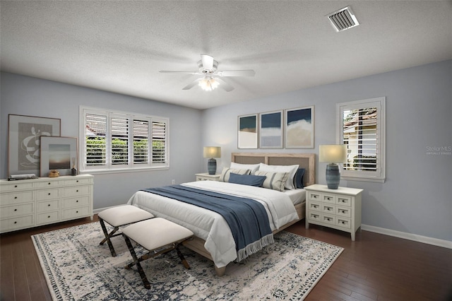 102 Cedar Way, Yalaha, FL 34797 - bedroom with multiple windows, dark wood-style floors, a textured ceiling, and ceiling fan