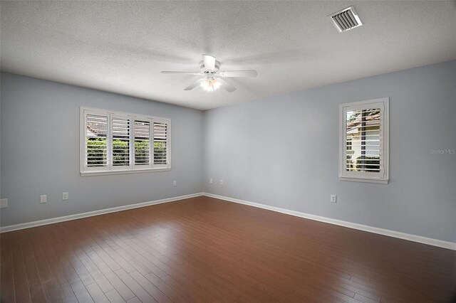 102 Cedar Way, Yalaha, FL 34797 - spare room with a ceiling fan, plenty of natural light, a textured ceiling, and dark wood-type flooring