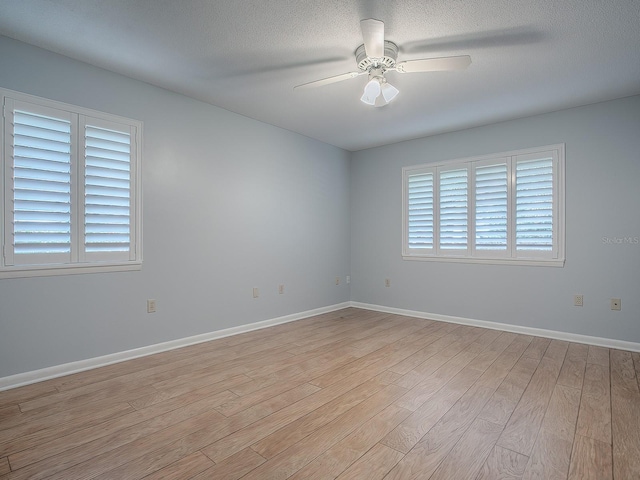 102 Cedar Way, Yalaha, FL 34797 - spare room with light wood-style floors, ceiling fan, and a textured ceiling
