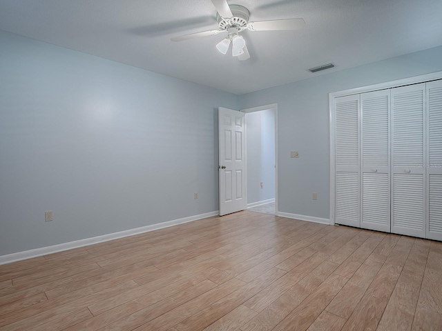 102 Cedar Way, Yalaha, FL 34797 - unfurnished bedroom with light wood-style flooring, a closet, and a ceiling fan