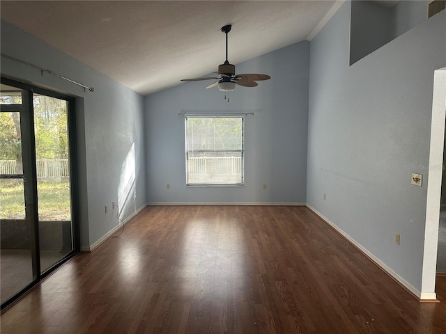 spare room with ceiling fan, dark wood-type flooring, and vaulted ceiling