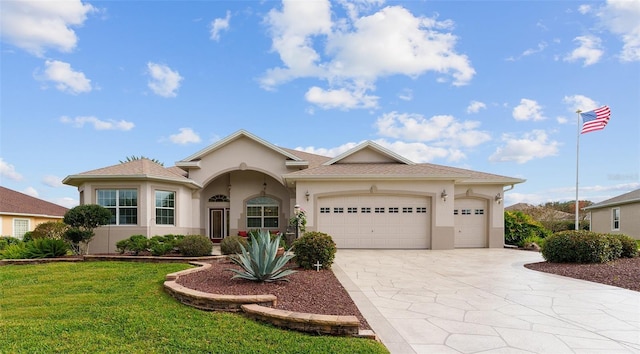 view of front of house with a garage and a front lawn