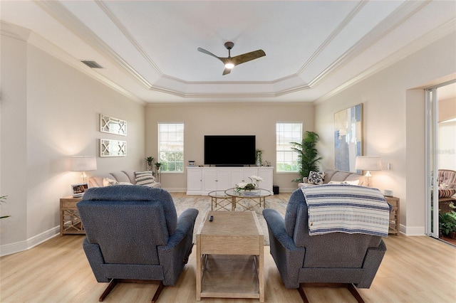 living room featuring light hardwood / wood-style flooring, plenty of natural light, crown molding, and ceiling fan