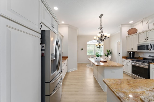 kitchen with white cabinets, stainless steel appliances, and a kitchen island