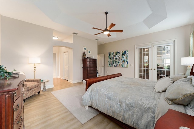 bedroom with access to exterior, ceiling fan, light hardwood / wood-style flooring, and french doors