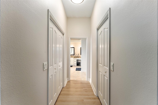 corridor with light hardwood / wood-style floors