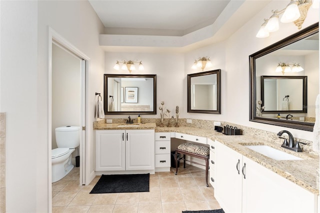 bathroom featuring tile patterned floors, vanity, and toilet