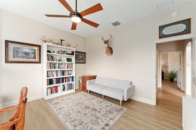 living area featuring ceiling fan and light wood-type flooring