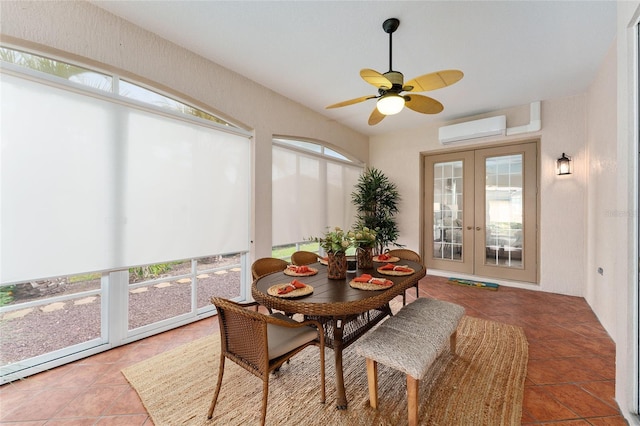 sunroom featuring a wall mounted air conditioner, french doors, ceiling fan, and a healthy amount of sunlight