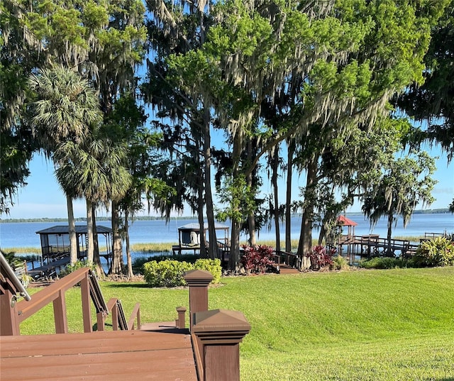 view of home's community with a yard and a water view