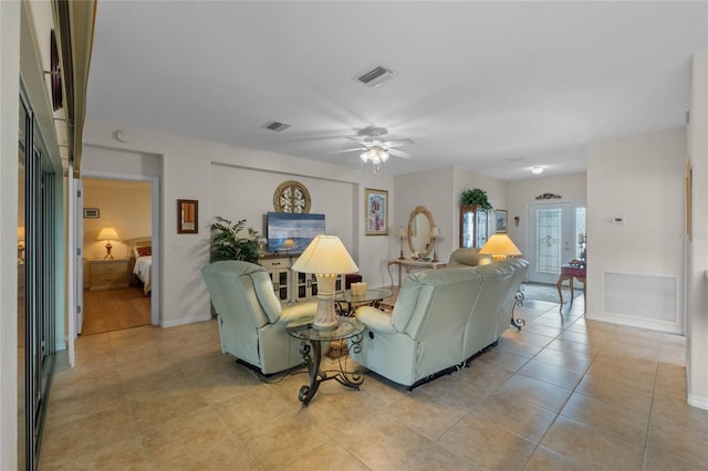 living room featuring light tile patterned floors, french doors, and ceiling fan