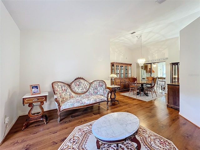 living area with a chandelier and dark hardwood / wood-style flooring