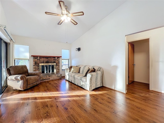 living room with a brick fireplace, ceiling fan, high vaulted ceiling, and hardwood / wood-style flooring